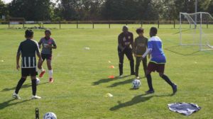 Action shot of Highfield Rangers Coach Compton Smith delivering a training session.