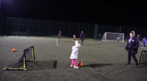 Wide shot of Kibworth Town coach Kelsey Leverton and a player.